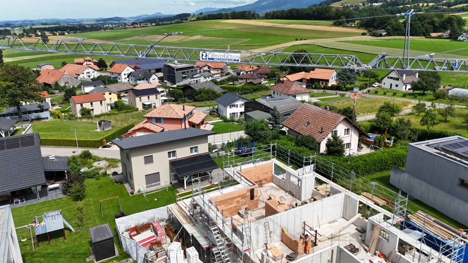 Site crane towering over the village